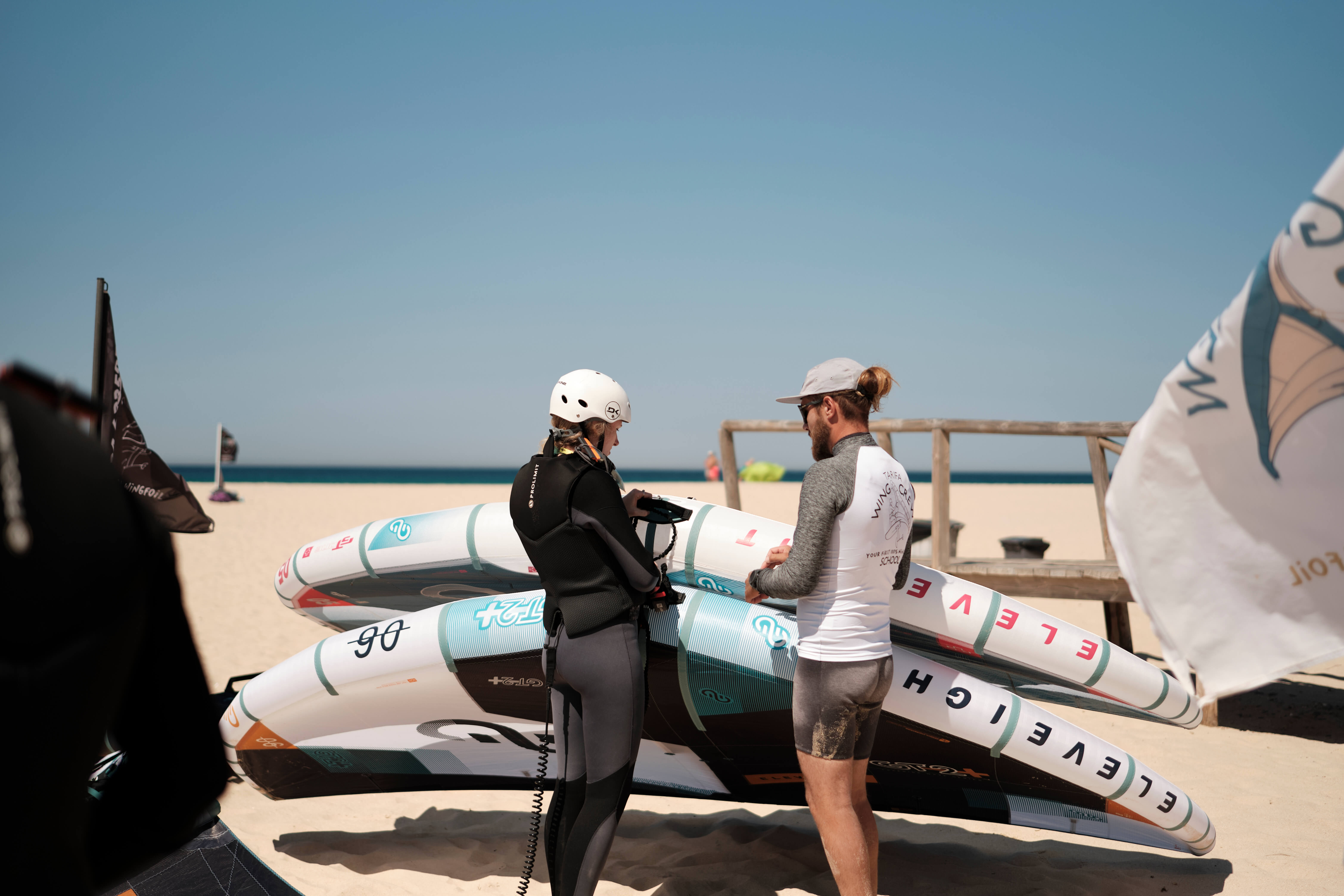 Student and instructor with wingfoil sails